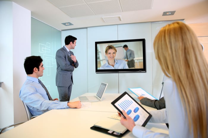 Business people attending videoconference meeting