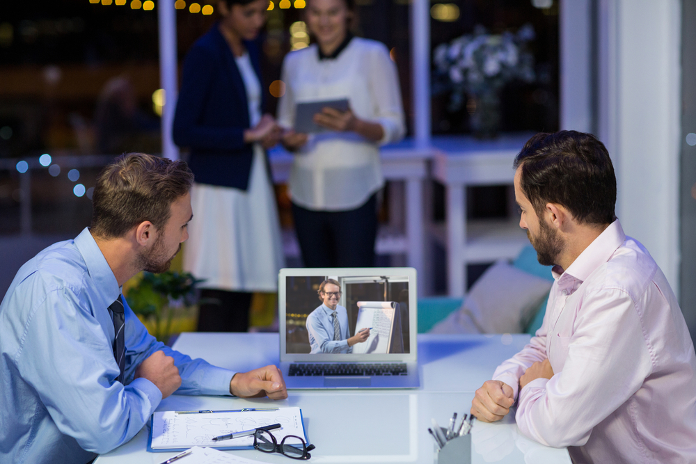 Businessmen having video conference in conference room at office-1